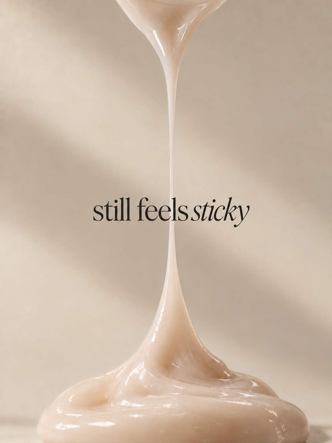 Thick skincare texture stretching upward in a long sticky strand.